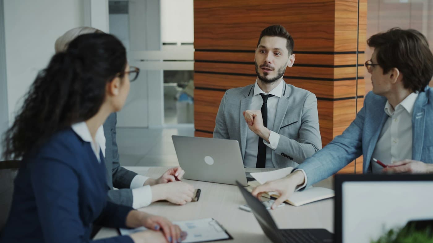 Business professionals discussing work around a conference table