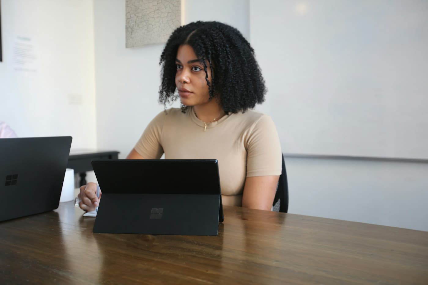 A professional reviewing information on a tablet at a conference table